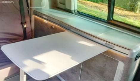 Photo of the pull out table inside of a VW campervan.