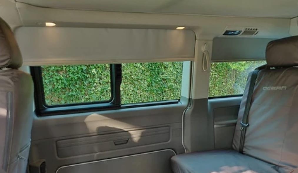 An image showcasing what curtains are supplied with the VW campervan for hire.